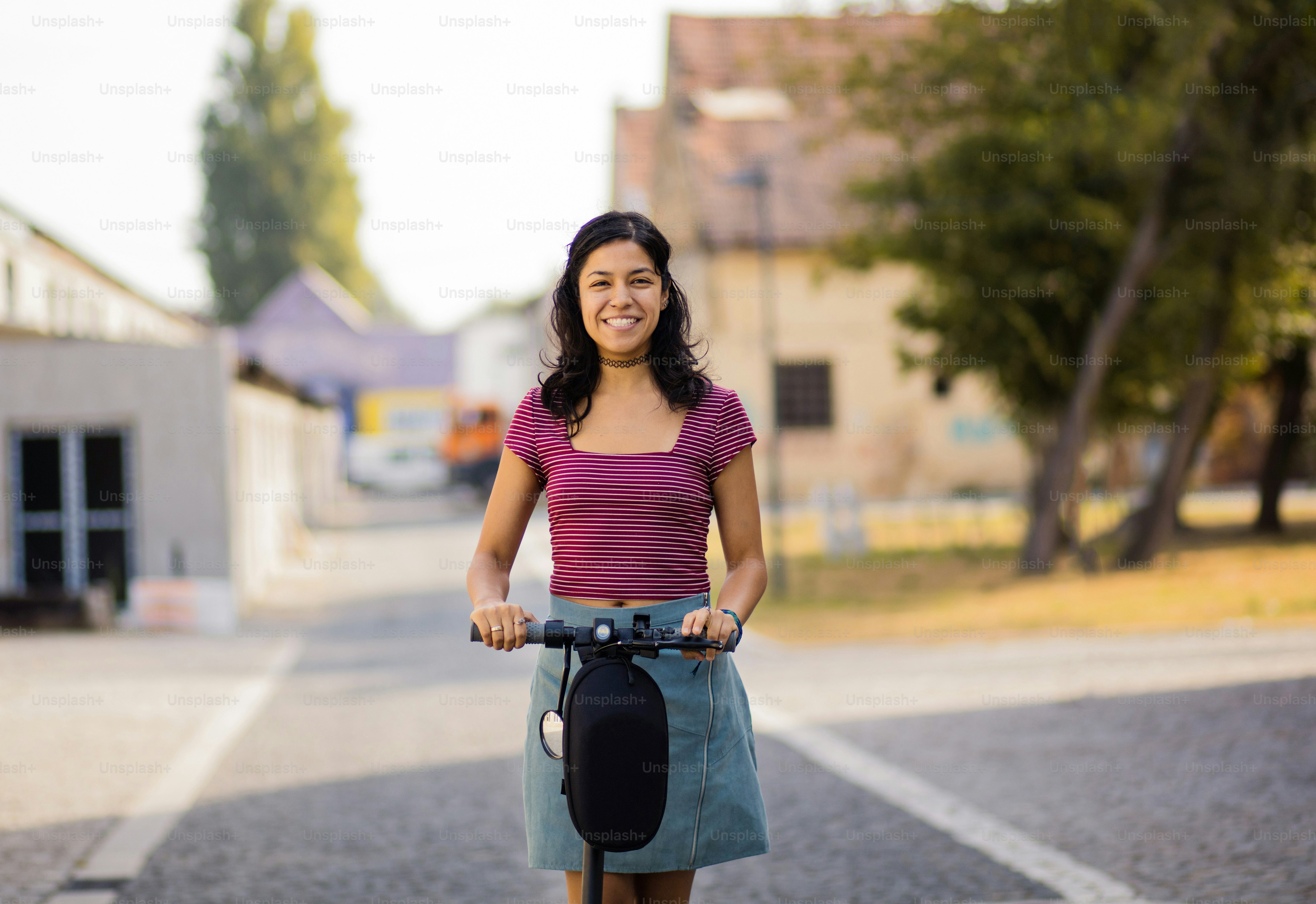 Woman riding scooter on the street. photo – Push scooter Image on Unsplash