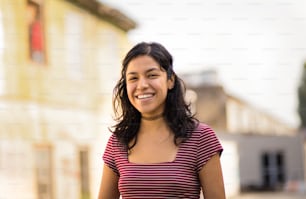 Portrait of smiling woman on street.