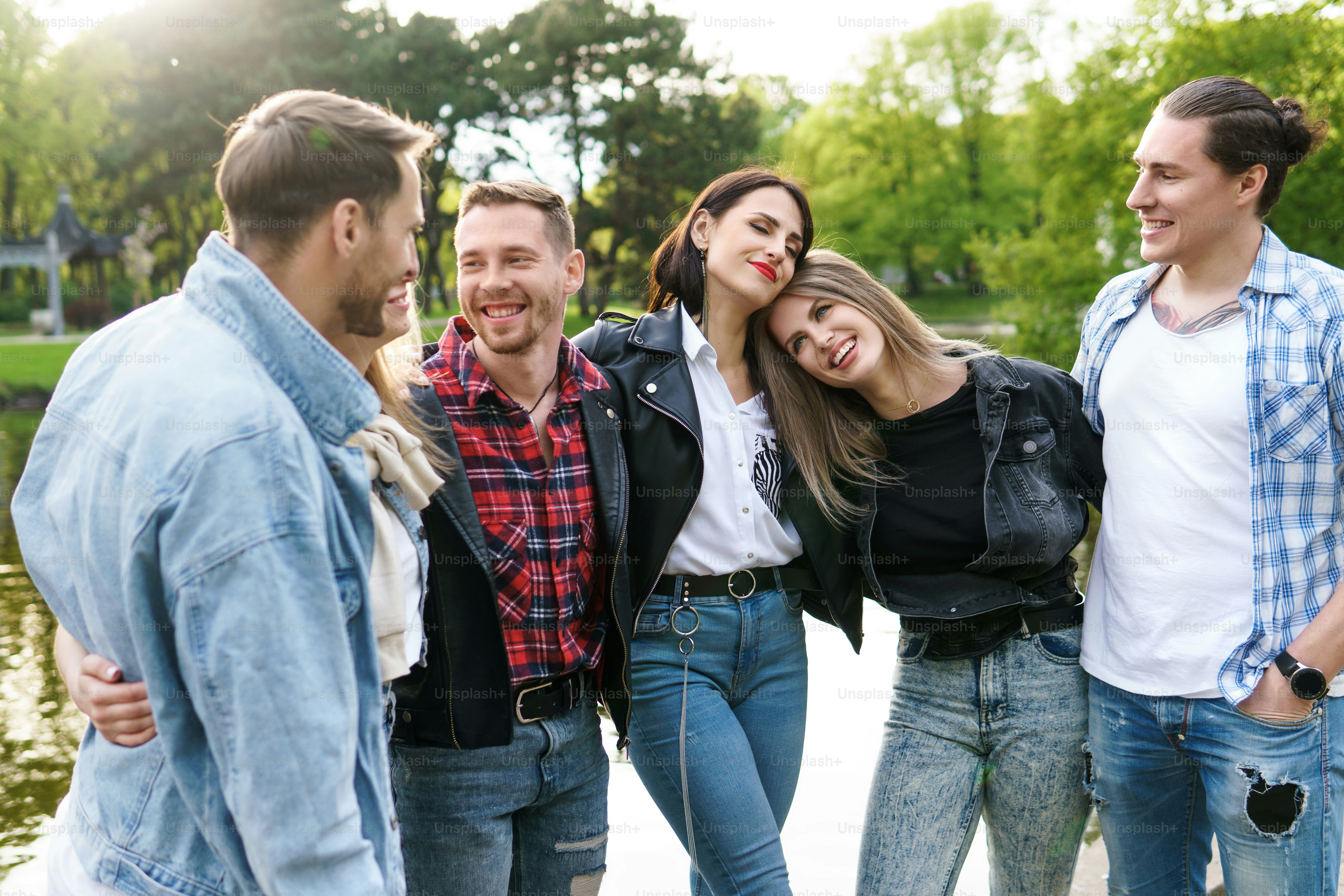 Group of best friends are having fun in a city park. Young people happy ...