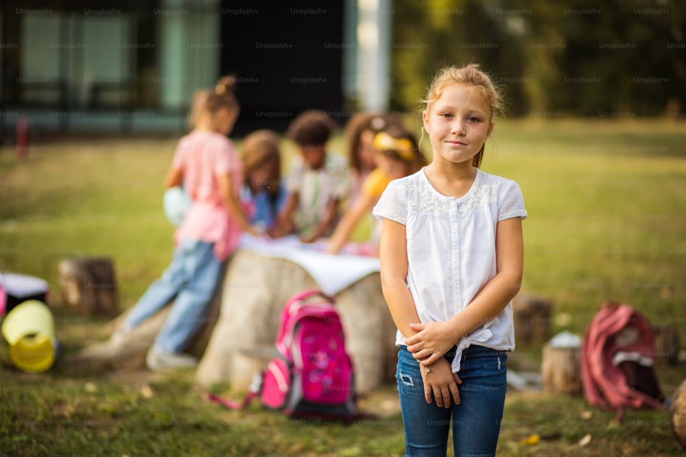 Portrait of school kid with red hair in nature. Focus is on foreground.