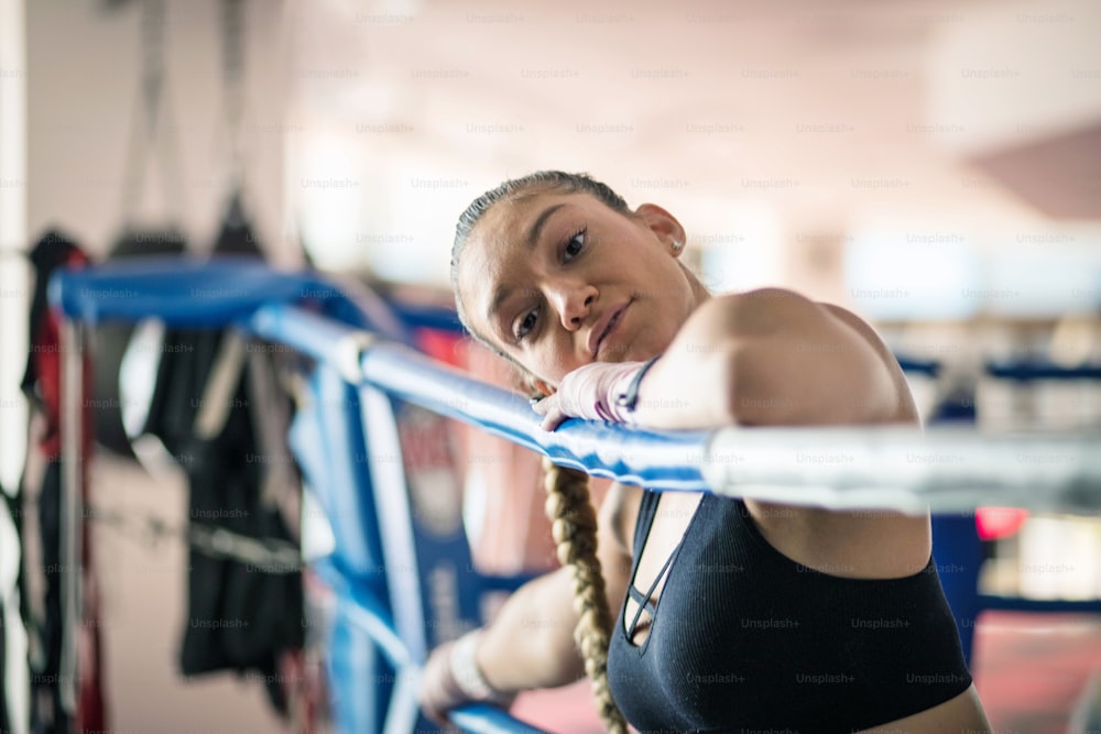 Female boxer in the boxing ring. Looking at camera.