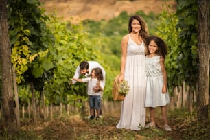 We love nature. Family in the vineyard. Portrait of mother and daughter looking at camera.