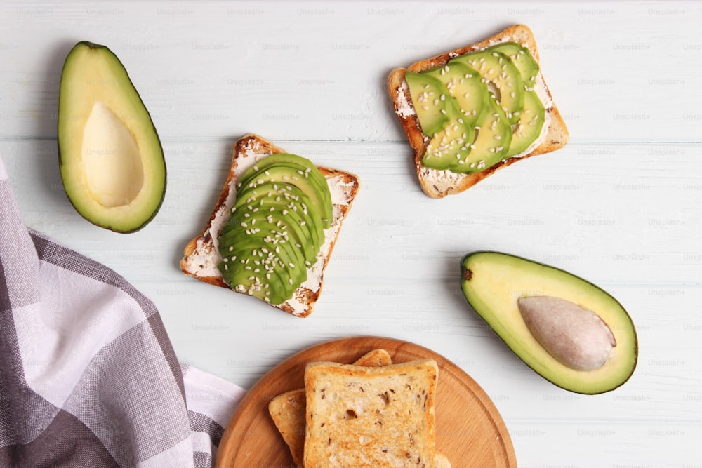 Toasted toast with avocado on a wooden table. High quality photo