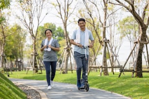 Couple workout and exercise with scooter together outdoor in park"t