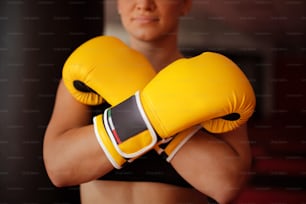 Boxer woman in gym. Focus is on hands.