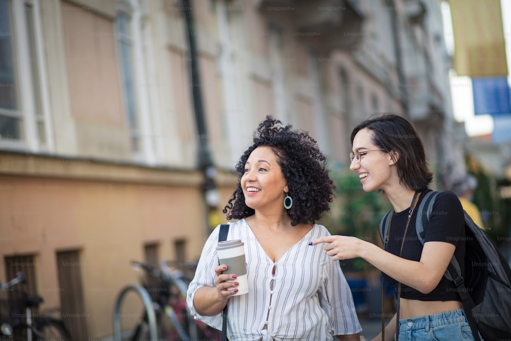 Two tourist women talking on street.
