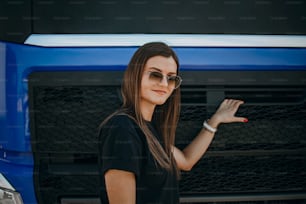 Professional female industrial truck driver performs technical inspection of the vehicle as safety measures before next drive.