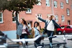 Three women having fun on the street.