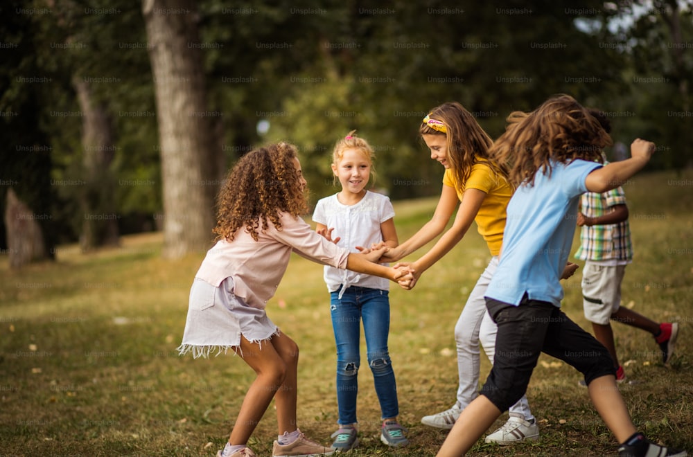 Large group of school kids having fun in nature.