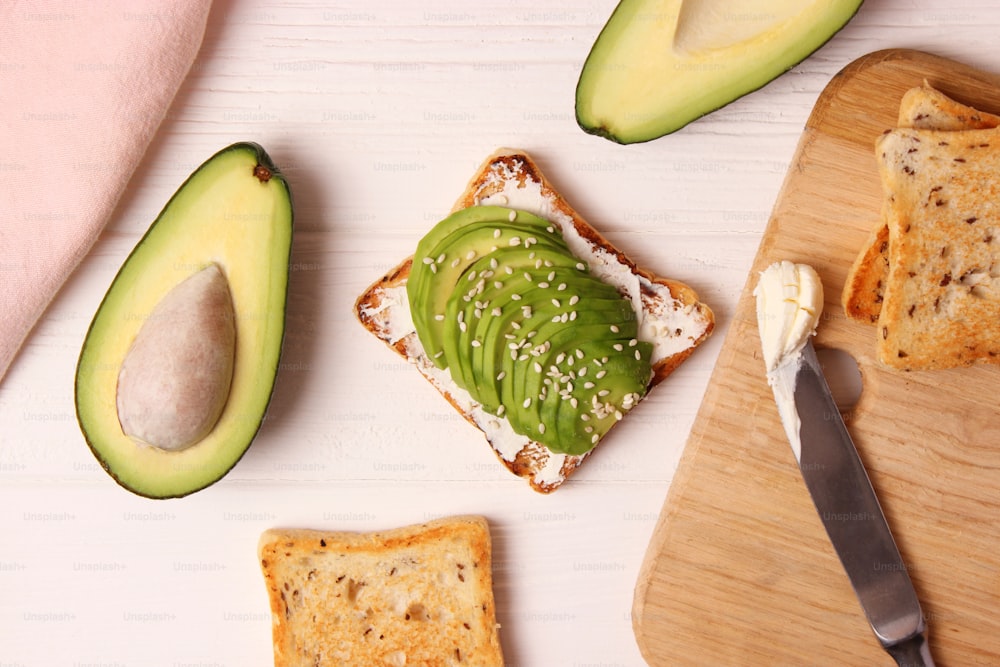 Toasted toast with avocado on a wooden table. High quality photo