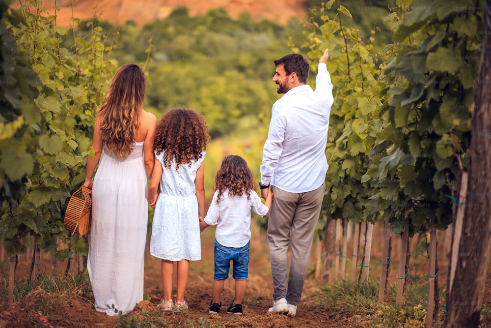 Family standing in vineyard.