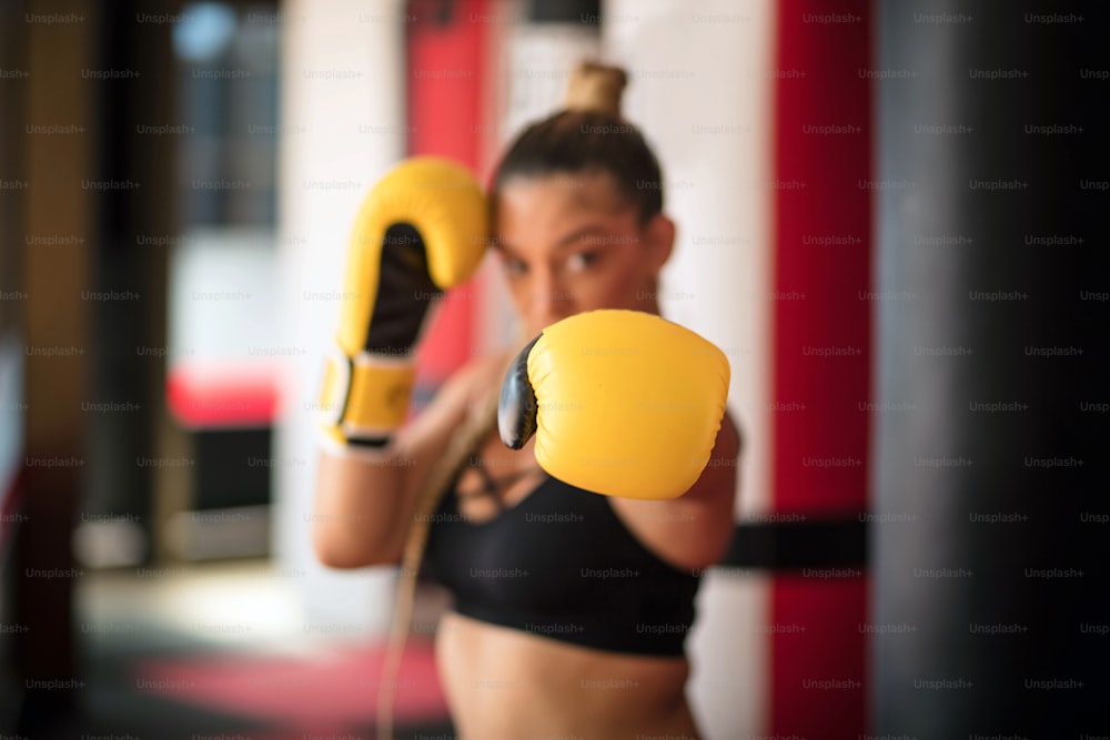 Boxer woman in boxing gloves. Focus is on hand.