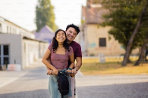 Young couple on electric scooter.