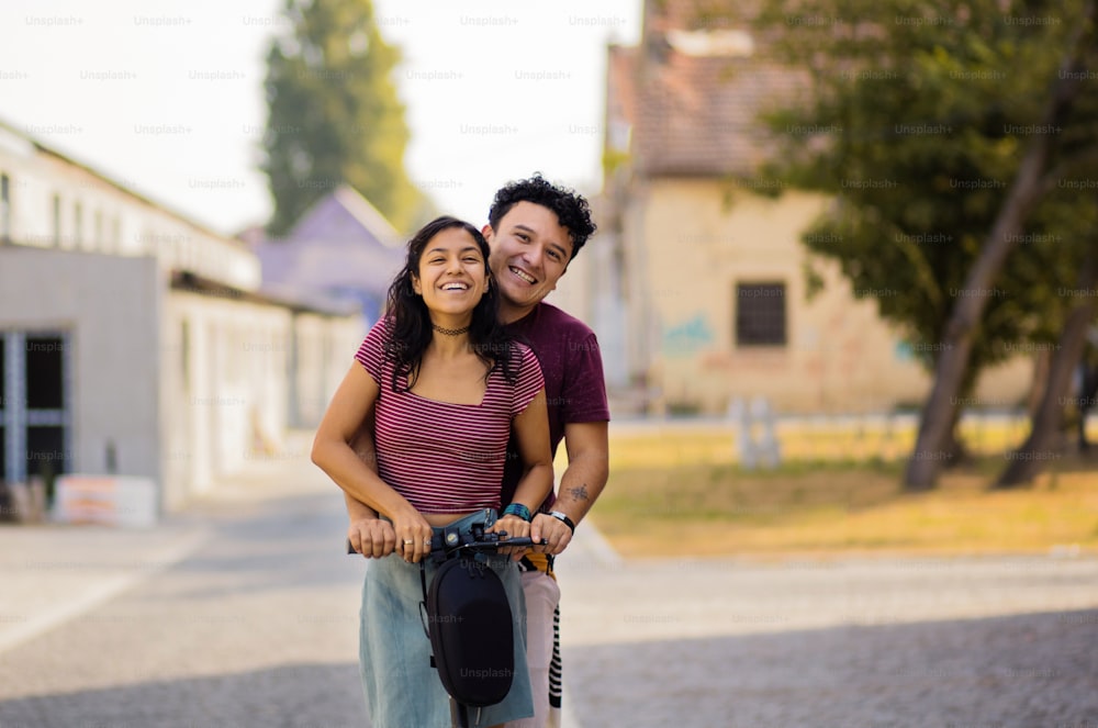 Young couple on electric scooter.