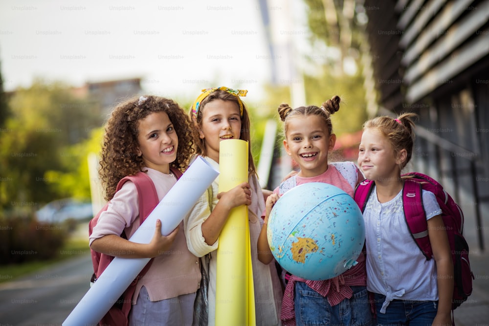 Portrait of four school girls standing outside.