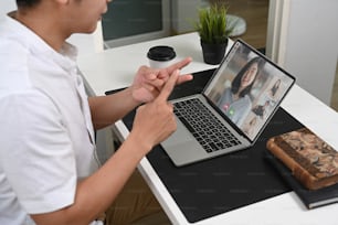 Cropped shot of businessman video conference with diverse colleagues during working from home.