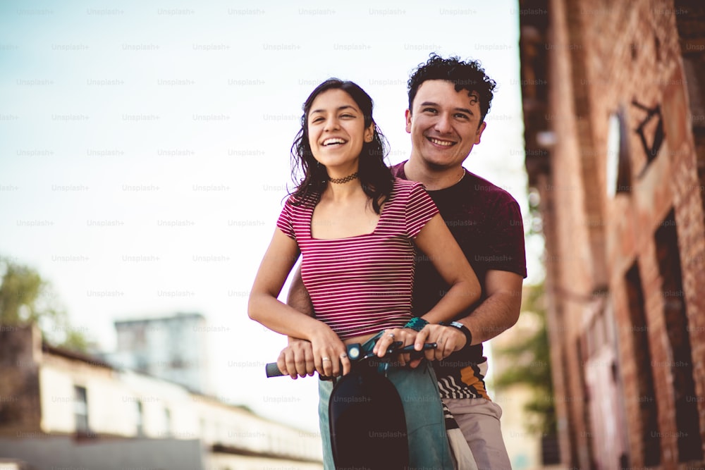 Young couple on electric scooter.