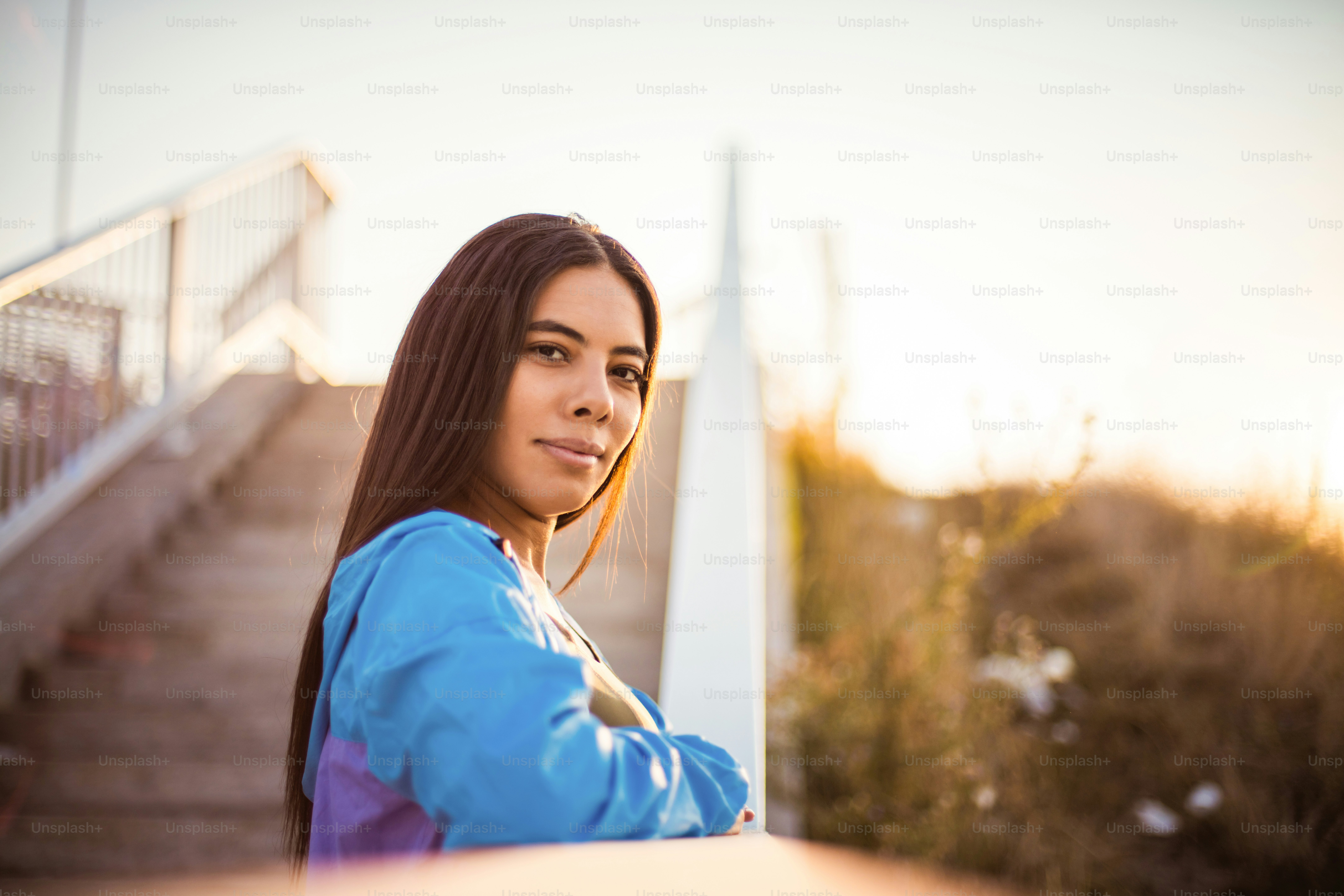 Sporty woman standing outside and looking at camera.