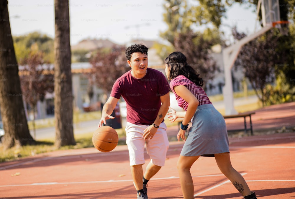 Young happy  couple playing basketball.