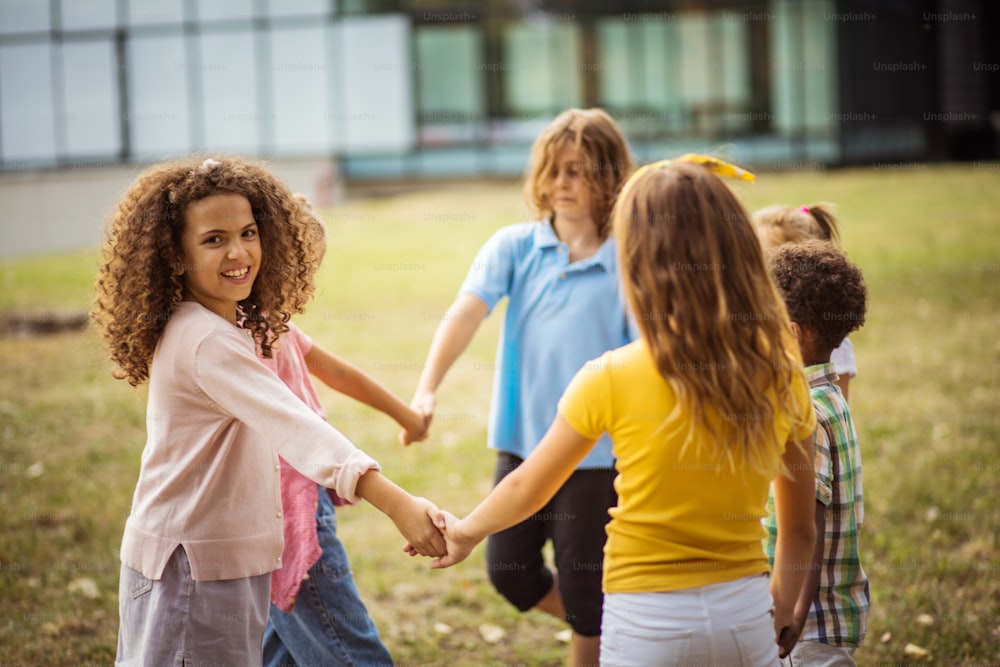 Large group of school kids having fun in nature.