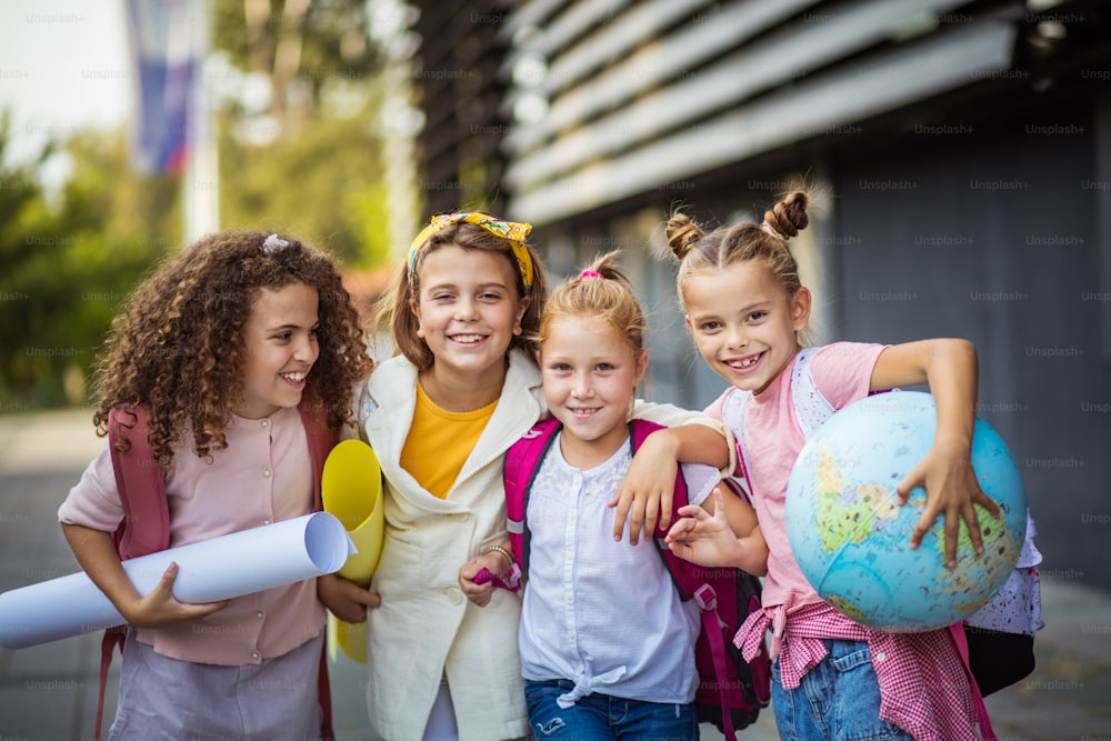 Portrait of four school girls standing outside.