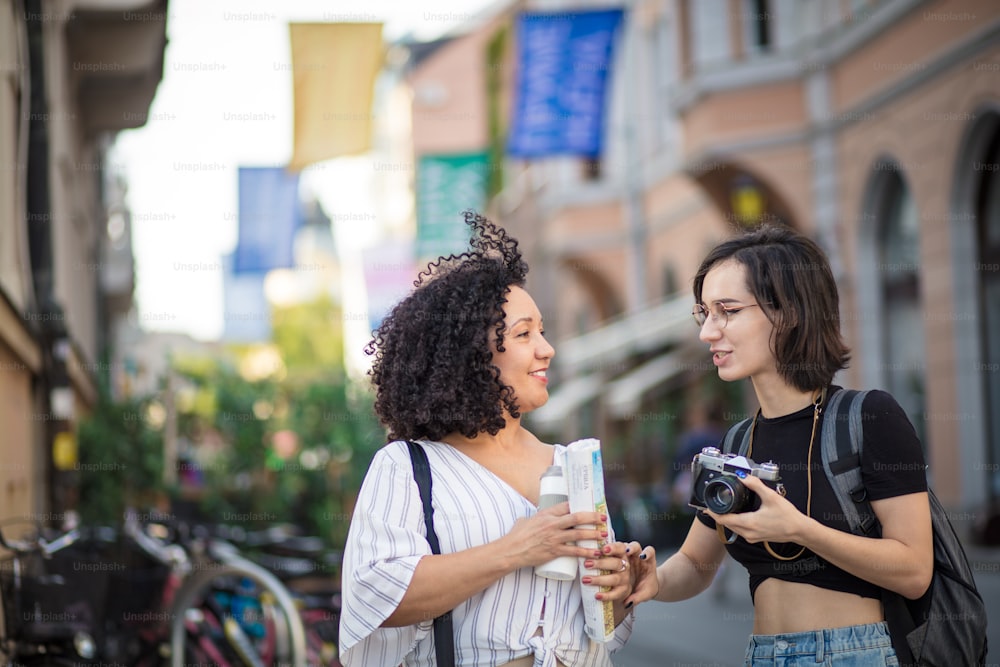 Friends tourists. Two tourist women on street.