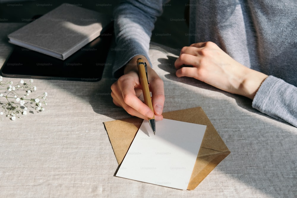 Woman writing romantic letter or wedding invitation card