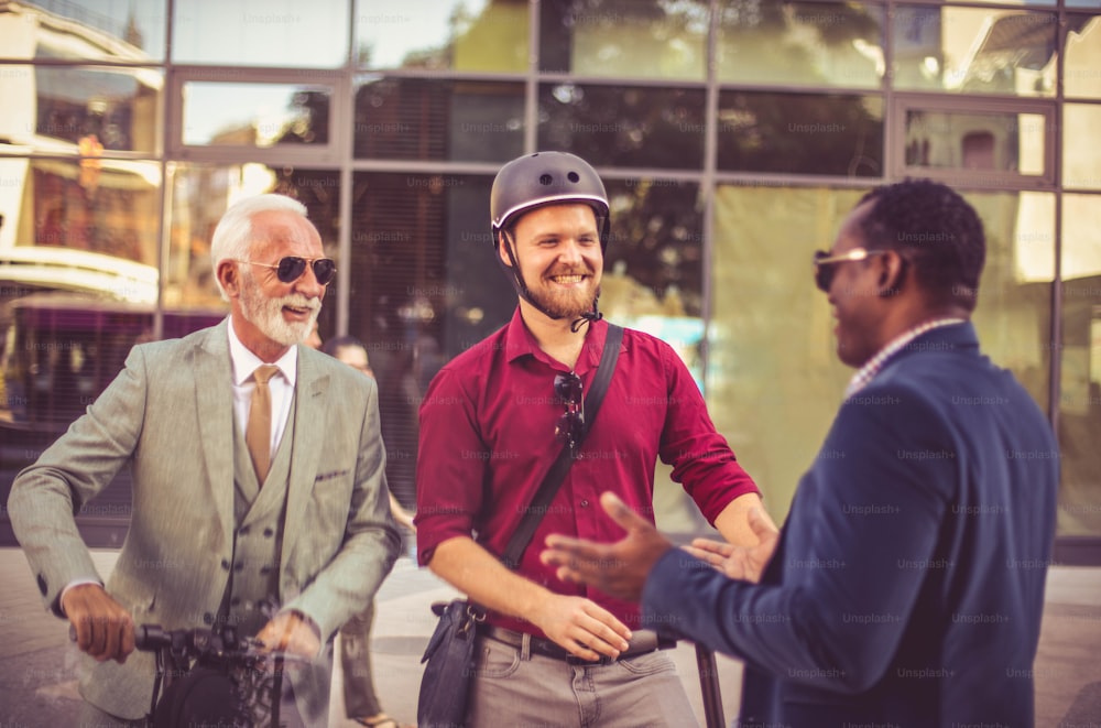 Three business colleagues standing outdoors and discussing.