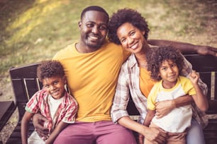 Portrait of happy African American family outdoors.