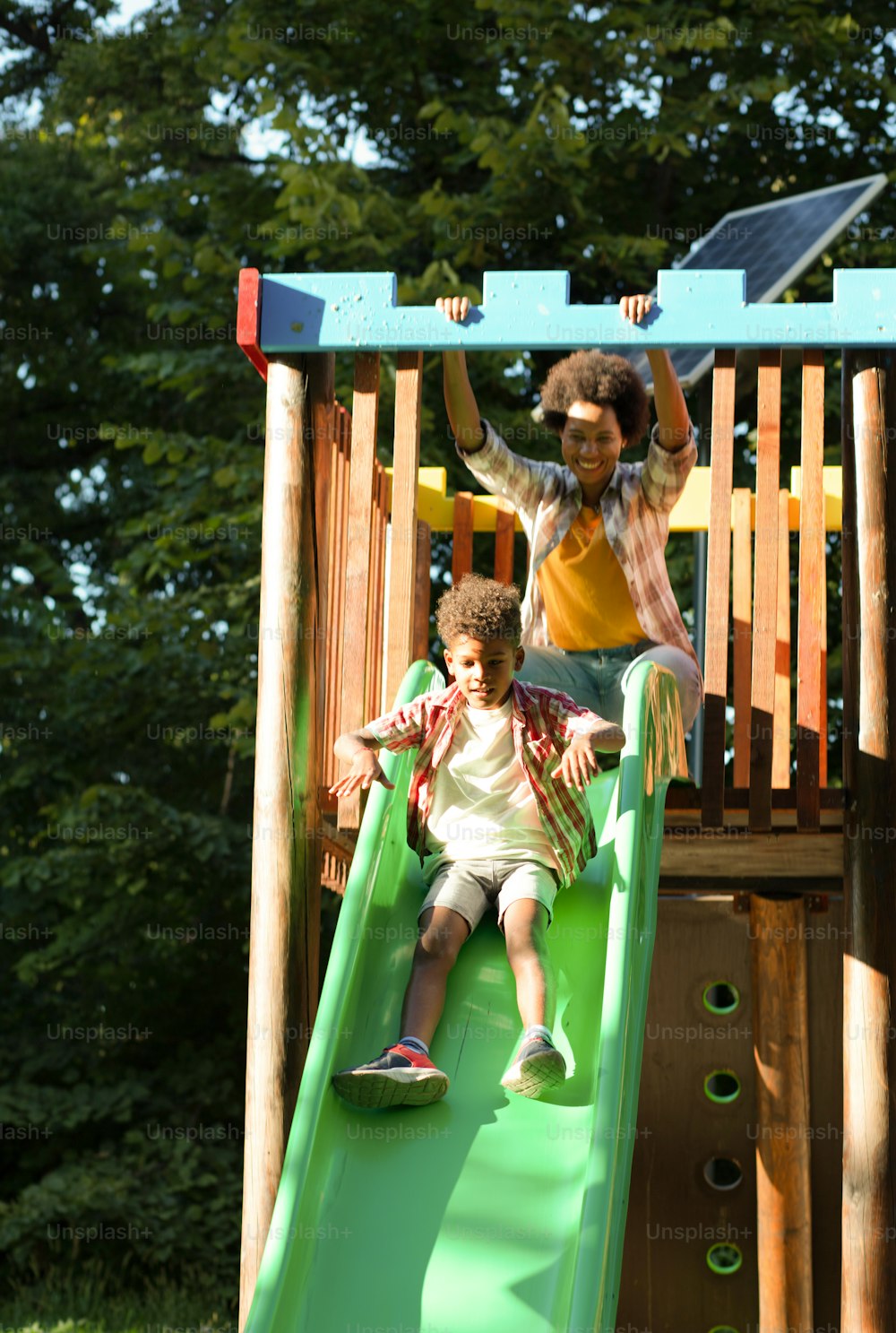 Mom and son having fun on toboggan.