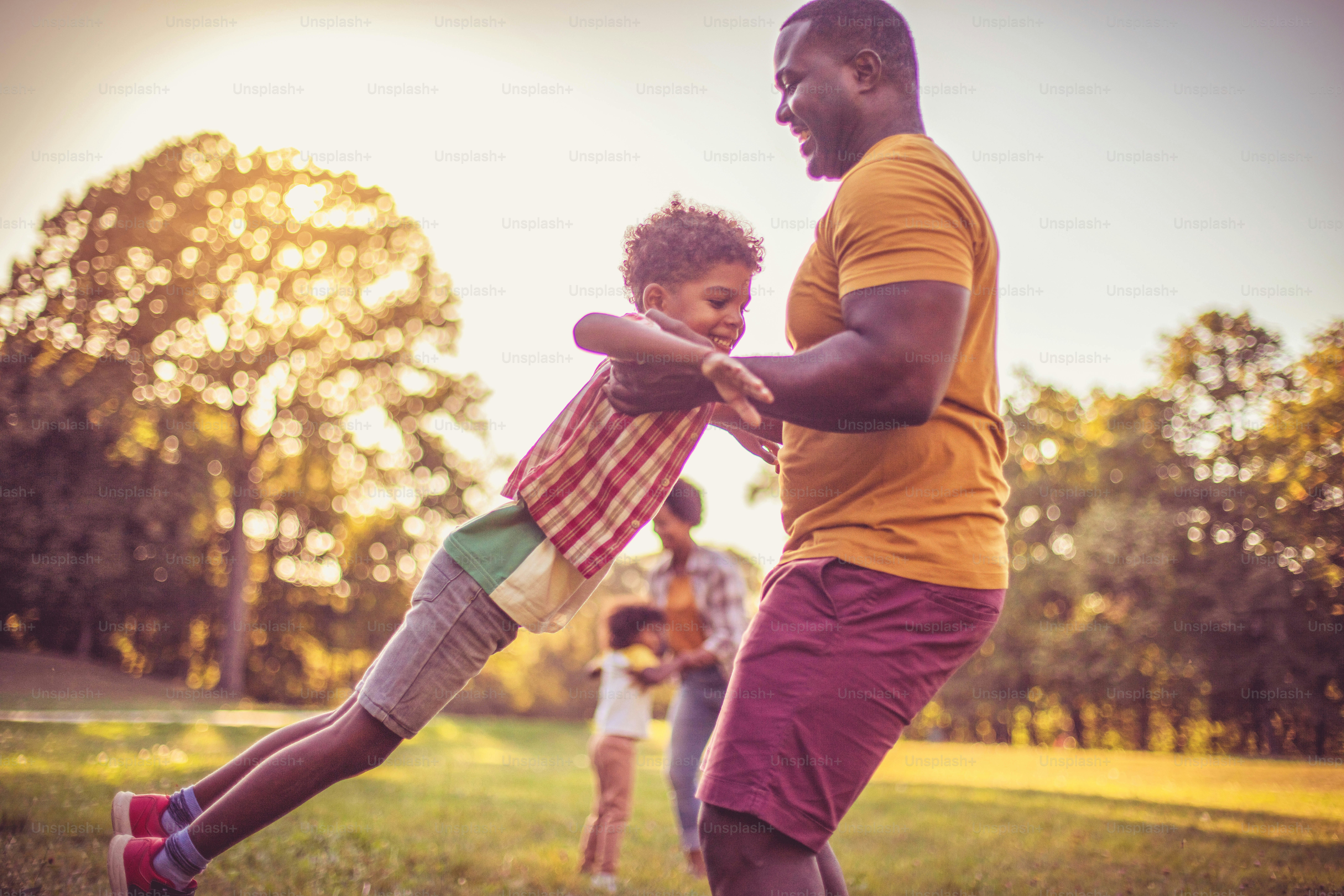 African American family having fun outdoors. Focus foreground.