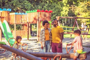 African American family having fun outdoors. Focus is on background.