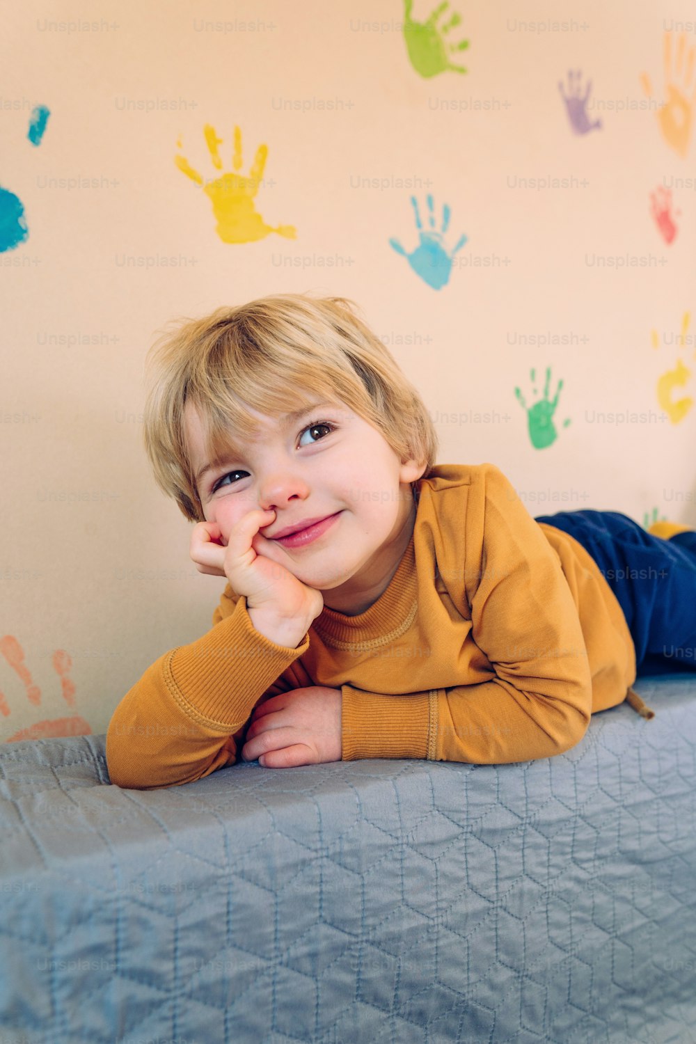 Funny 3 years old boy lying on the sofa in the kids room photo – Indoors  Image on Unsplash