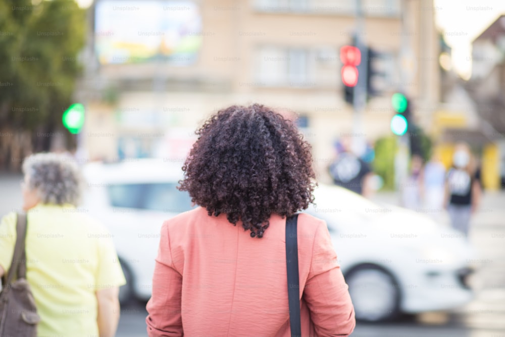 Business woman walking on the street. She goes home.