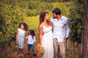Family in the vineyard. Focus is on couple.