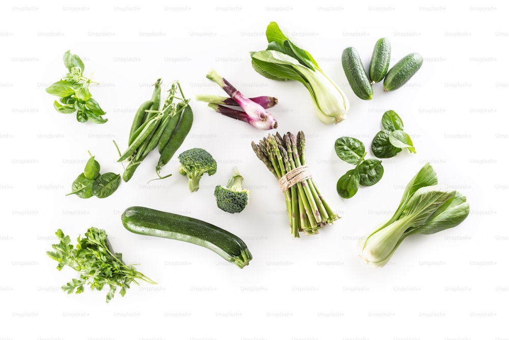 Assorment of fresh green vegetables isolated on white background.