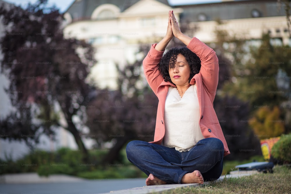 Business woman working yoga on the street.