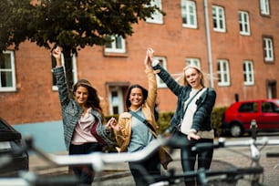 Three women having fun on the street.