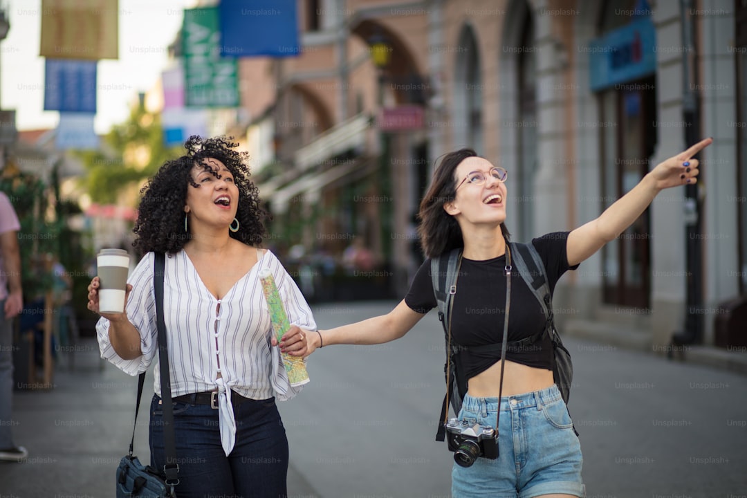 Two tourist women on street. Time for fun.
