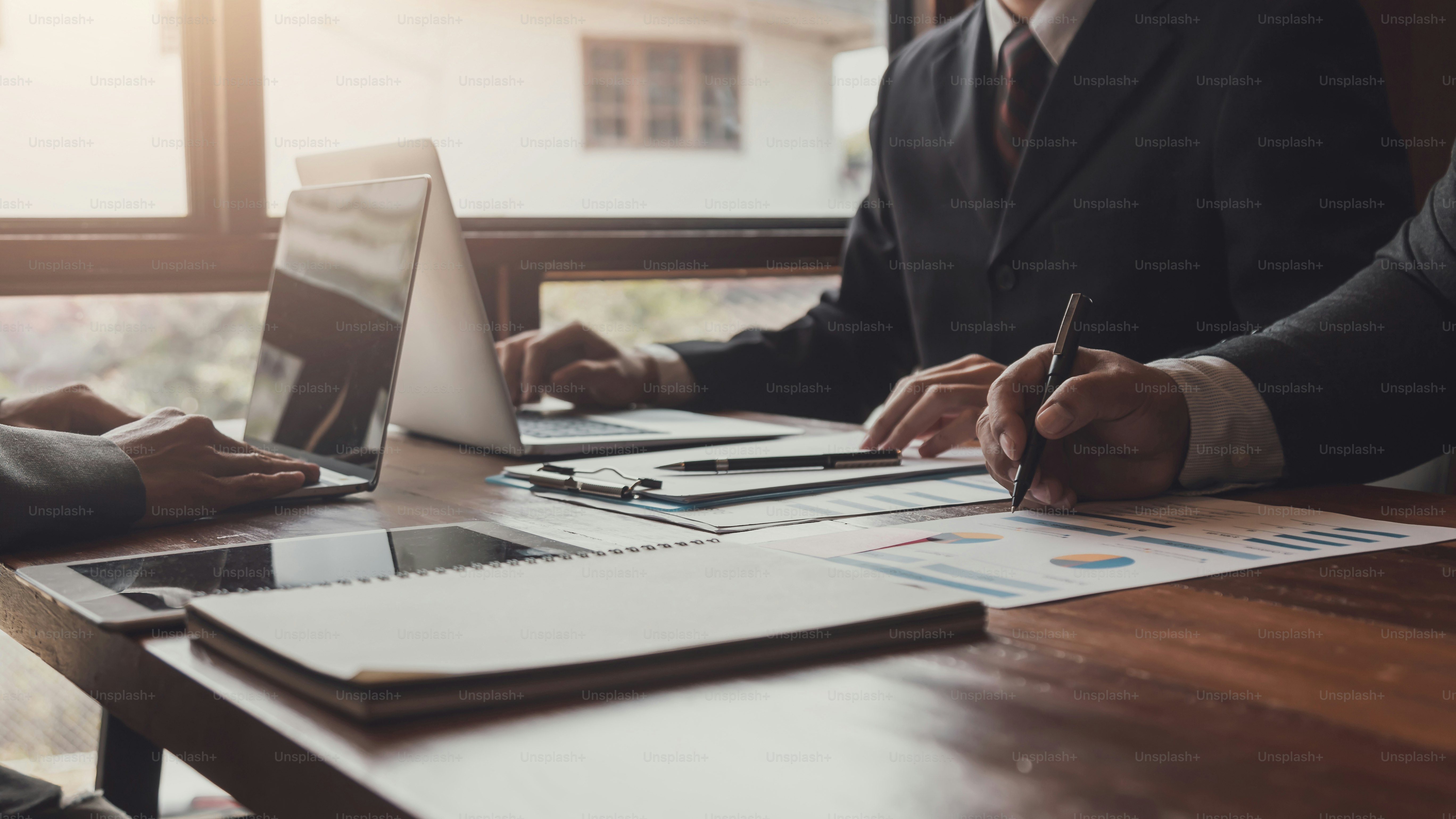 Business executives sit together in a business strategy planning meeting.