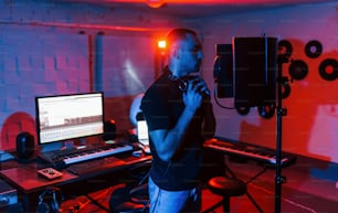Vocalist have recording session indoors in the modern professional studio.