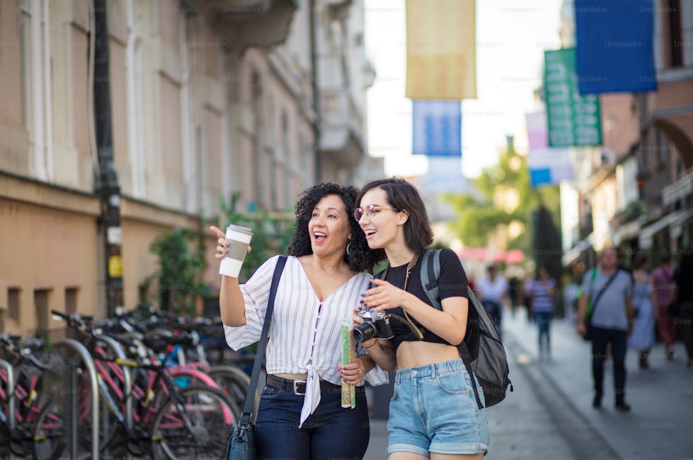 Lets go there.  Two tourist women on street.