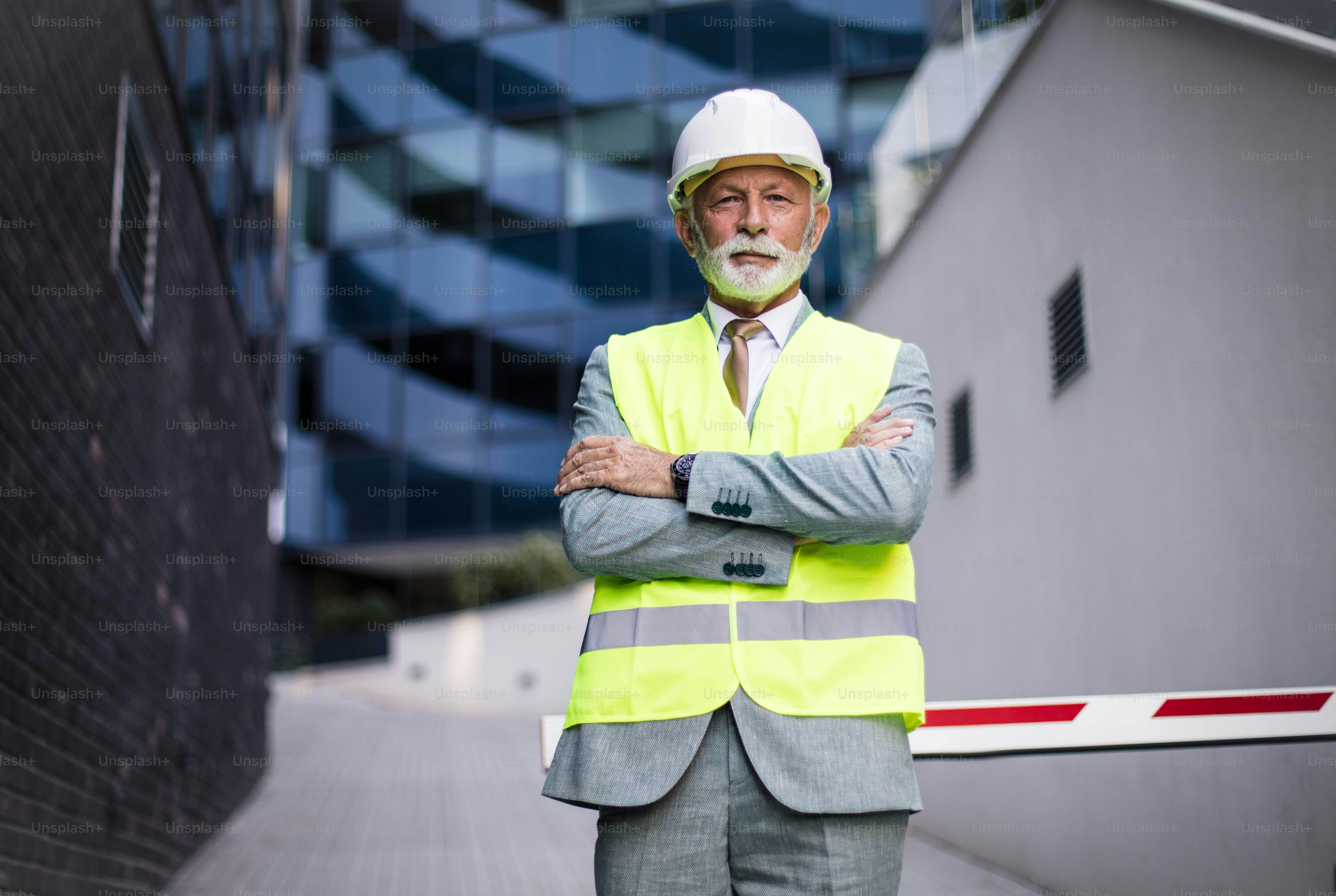 Smiling engineer standing on the street. Looking at camera.