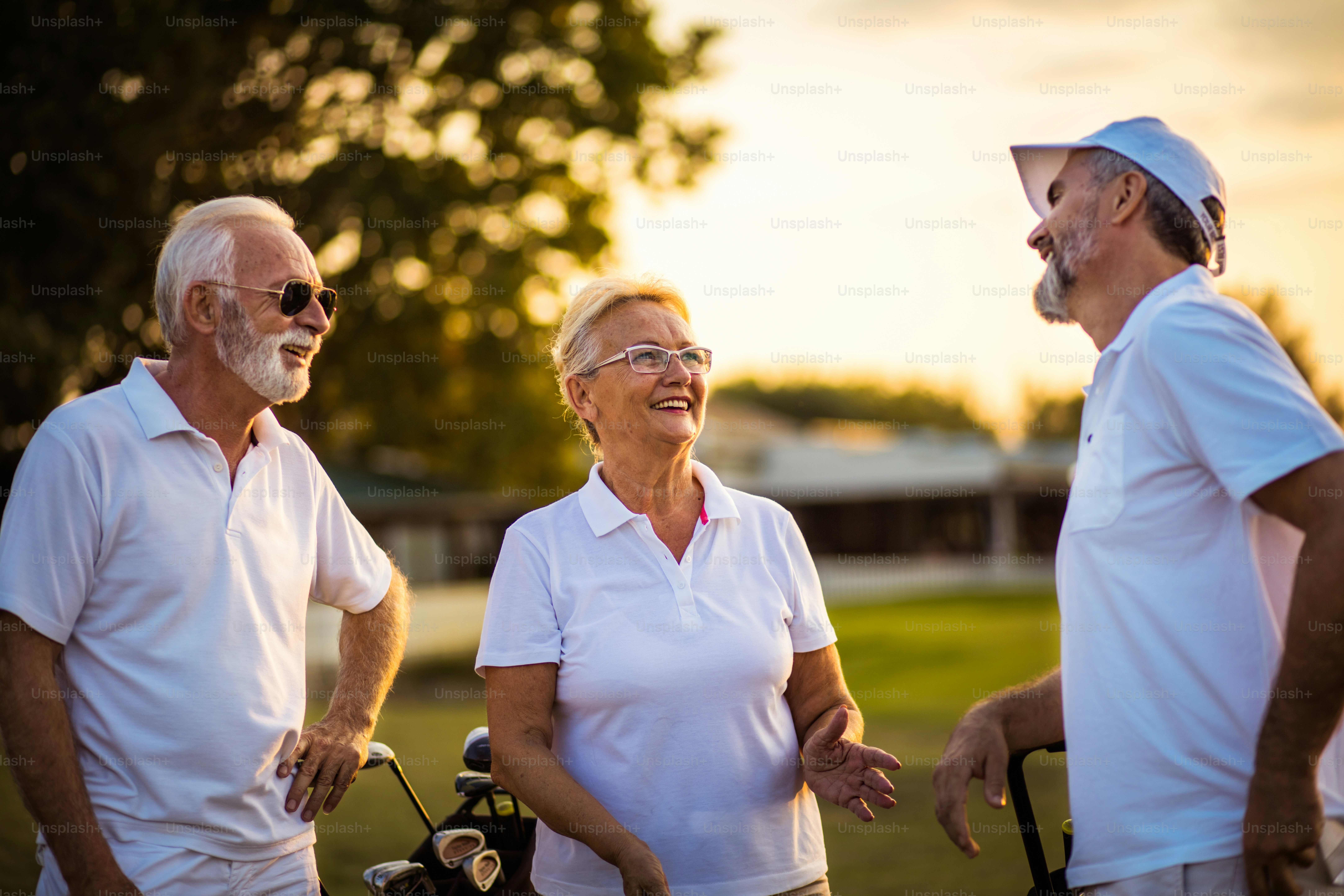 Three seniors golfers talking on golf field. photo Serbia Image on