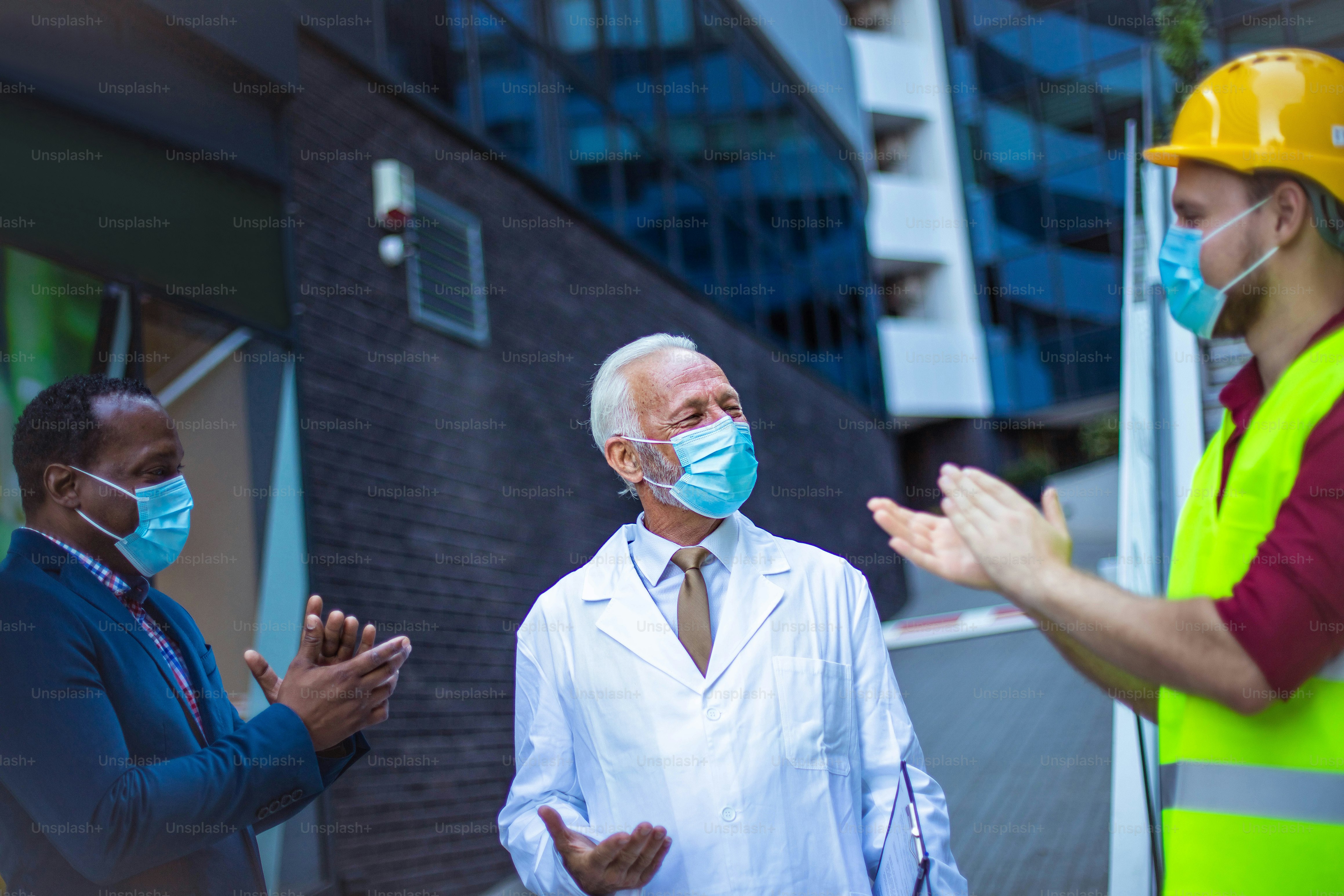 Business man, doctor and engineer talking on street.