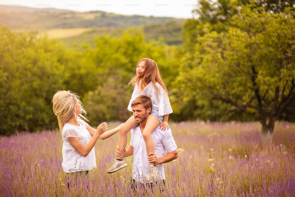 The family stands in a lavender field.