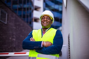 Smiling engineer standing on the street.