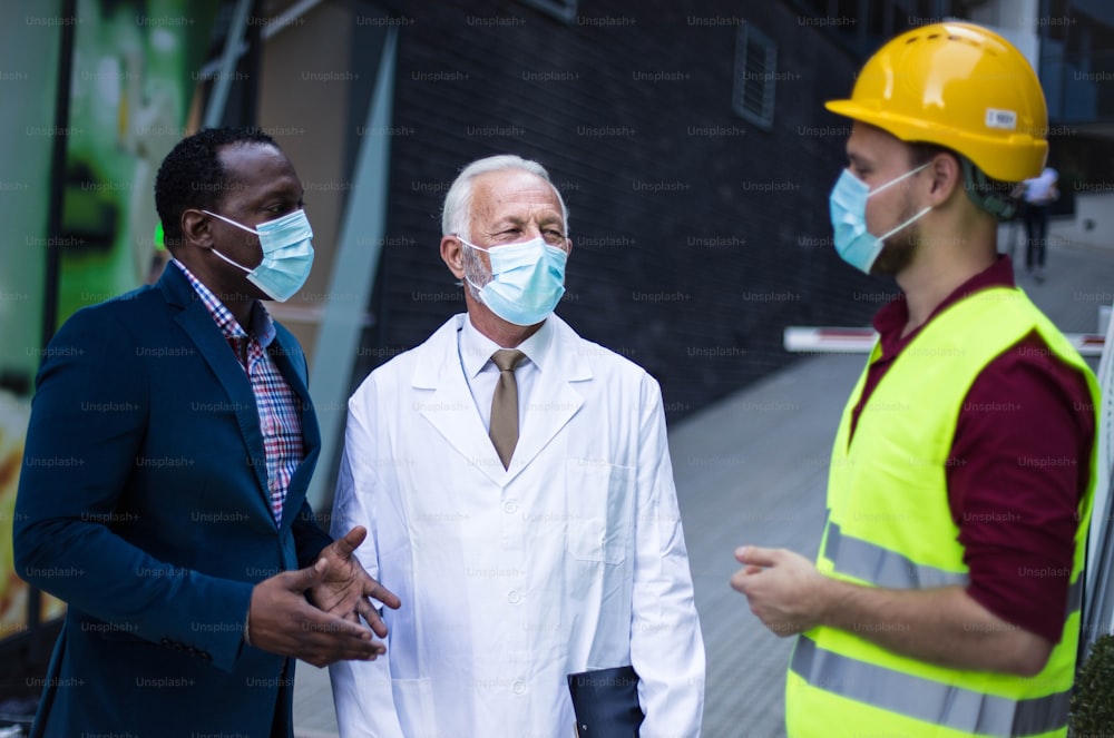 Business man, doctor and engineer talking on street.