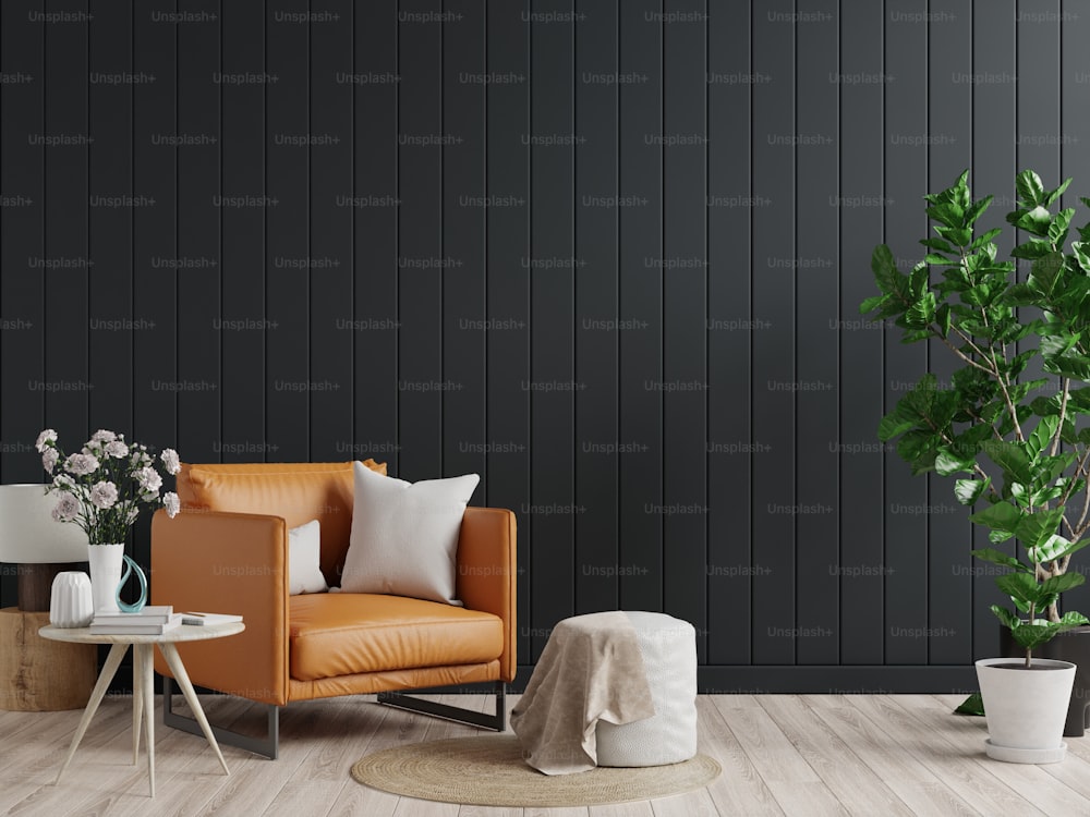 Maqueta de pared interior de sala de estar en tonos oscuros con sillón de cuero sobre fondo de pared de madera negra.3d renderizado