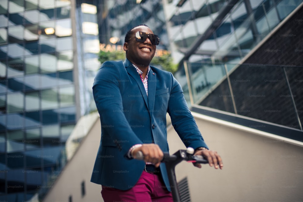 Uomo d'affari in sella a scooter elettrico in città.